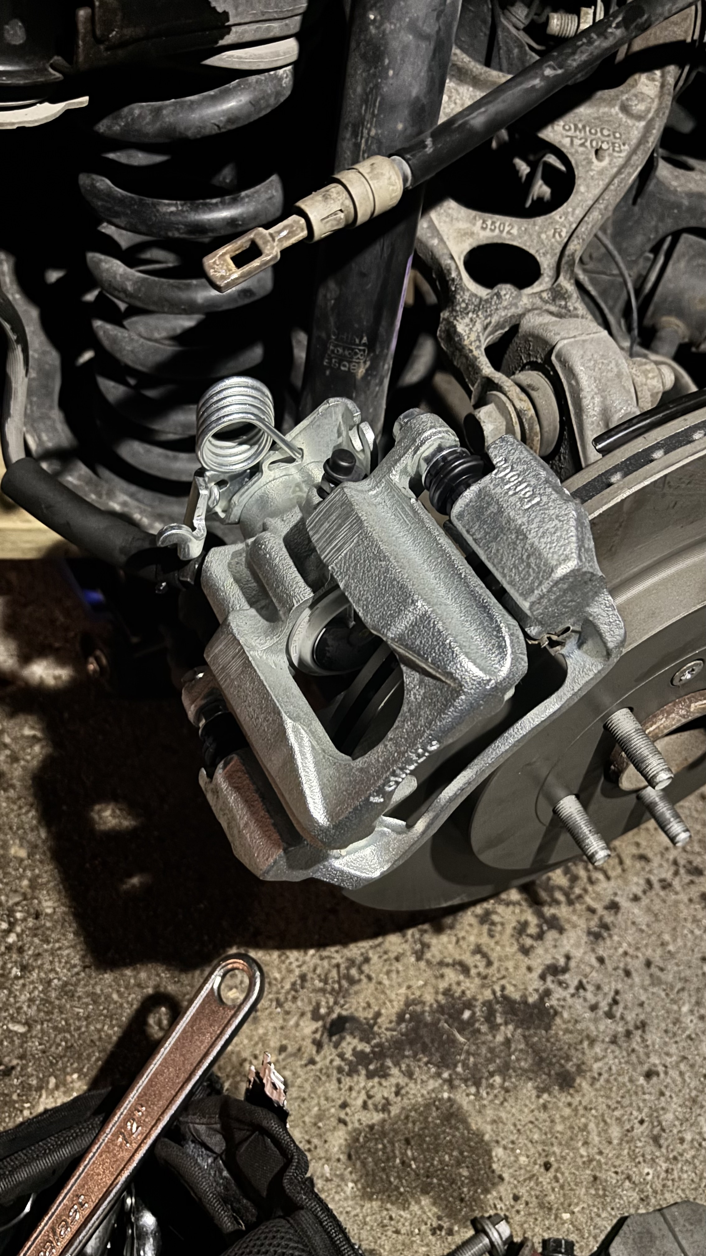 Brake rotor and caliper being serviced